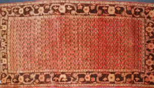 An early 20th century large Persian Bokhara rug with multiple field of unusual medallions having