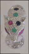 A silver ladies Panther ring inset with semi-precious stones and ruby eyes. Size R / Weight 5.
