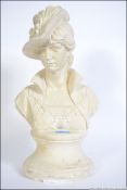 A large plaster bust - study of a burlesque maiden raised on a socle plinth base.