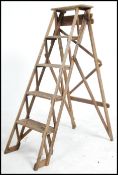 An early 20th century wooden trellis - lattice worked Industrial step ladder.