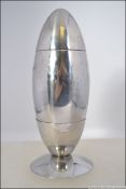 A silver plated 20th century missile - atomic shaped cocktail shaker on stand. Measures 18cms high.