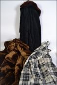 A group of three vintage and retro ladies coats to include two simulated furs and a woolen coat.