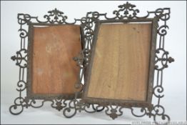 A pair of Victorian cast metal picture frames having lattice worked adams revival borders.