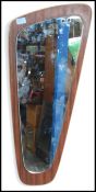 A 1970's retro teak Atomic style wall mirror of angular form with teak back plinth and frameless