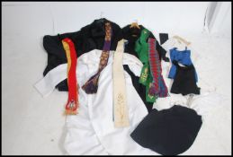 A collection of vintage priest / clergyman's robes to include cassocks, capes, hats, vestments etc.