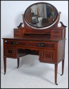 A quality Edwardian mahogany inlaid dressing table chest being raised on square tapered legs with a