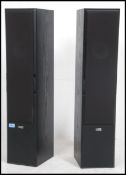 A pair of 20th century Acoustic Energy speakers of pedestal form having tall bodies with ebonised