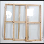 A group of three late 19th century early 20th century pine glazed cupboard doors.