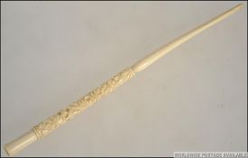 An extremely long vintage circa 1920's carved bone Cheroot holder with continuous floral carvings