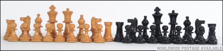 An early 20th century weighted club chess set, likely ebony and box wood.