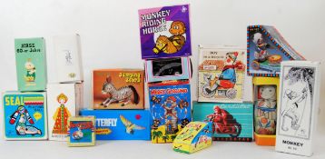 TINPLATE: A collection of assorted boxed Russian / Chinese / Japanese tinplate clockwork toys,