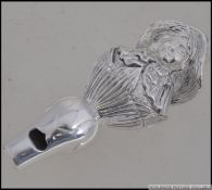 An unusual silver plated whistle in the