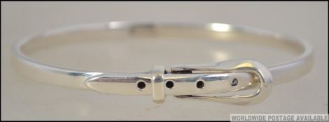 A silver ladies bangle in the shape of a