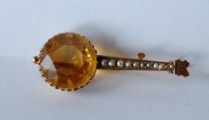 A 9ct gold Victorian brooch pin in the form of a Banjo with large prong set yellow tourmaline,