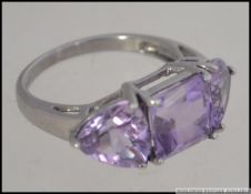 A 9ct white gold and trilogy amethyst ri