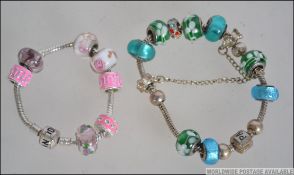 A pair of ladies silver metal bracelets