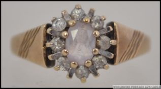 A 9ct gold cluster head ring being hallm