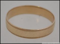 A 9ct gold hallmarked band ring with eng