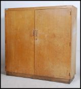 A 20th century beech wood school cupboar