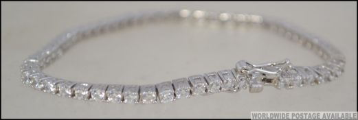 A ladies silver and cz line bracelet. Ea