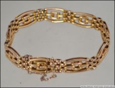 A 9ct gold bracelet of bar link form com