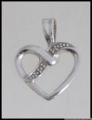 A 9ct white gold necklace pendant in the