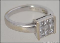 An 18ct white gold and diamond cluster a