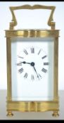 A good brass carriage clock with glass facia and shaped handle.