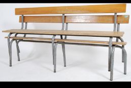 A pair of vintage / retro mid 20th century tubular industrial benches having slatted seat and back