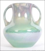 WITHDRAWN William Moorcroft - A twin handled lustre vase of ovoid form decorated in an apple