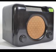 A vintage 1930's Art Deco bakelite radio model DAC90 having decorative facia on shaped case