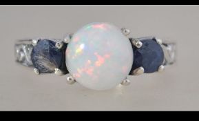 A silver, sapphire and opal adorned 3 stone ladies dress ring. Total weight 5.3g / Size R.5.