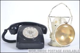 A vintage retro black ring dial telephone together with a vintage railways two way lantern with
