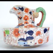 A 20th century Ironstone wash bowl and matching jug in the Imari pattern in the manner of Mason's.