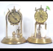 2 Cased anniversary 400 day clocks with spherical pendulums.