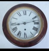 A 20th century stained pine station clock of circular with convex glass and roman numeral chapter