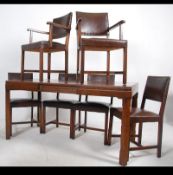 A 1930's Art Deco oak Waring & Gillows dining table together with a set of oak dining chairs.