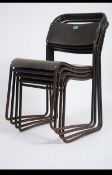 A stack of four vintage mid century industrial cox stacking chairs having panel seats and back