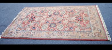 A large 20th century machine woven rug having floral borders,
