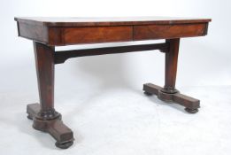 A Regency 19th century rosewood writing table desk raised on inverted tapering column supports with