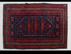 An early 20th century Persian prayer rug of good size having central mihrab with tree of life