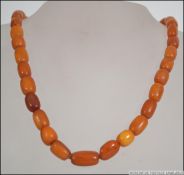 An early 20th century string of butterscotch amber graduated beaded necklace.
