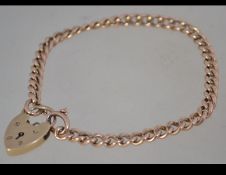A 9ct gold chain link bracelet with heart lock. Hallmarked for London. Weight 12.5g.