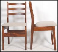 A set of 4 retro 1970's Danish influence teak wood bar back dining chairs raised on shaped legs