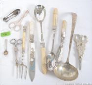 A collection of silver hallmarked and silver flat wares to include pickle fork, ladel, sugar nips,