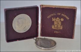 A 1951 Festival of Britain George VI five shilling crown coin complete in the box together with a