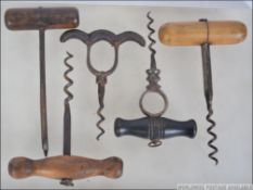 A collection of corkscrews to include a 19th century leather handled ' moustache ' corkscrew,