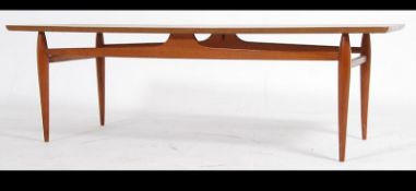 A 1970's teak wood Danish influence coffee occasional table raised on turned legs with upper