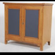 A 20th century low satin wood school cupboard.