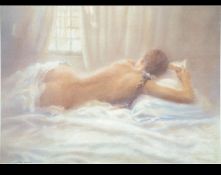 A framed and glazed limited edition signed print of a scantily clad recumbant reclining nude.